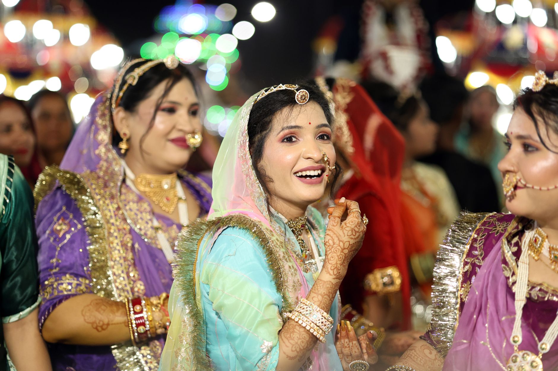 Joyful women in traditional attire celebrating a cultural festival in Indore.